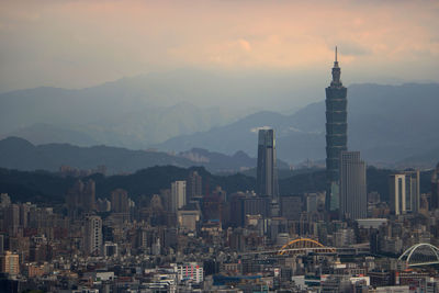 View of buildings in city during sunset