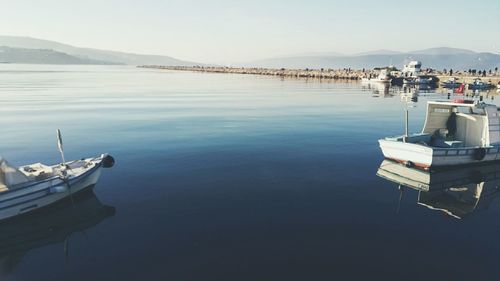 Boats moored on sea against sky