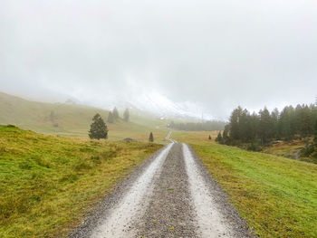 Empty road along countryside landscape