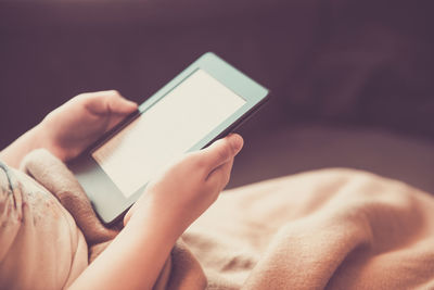 Midsection of man using mobile phone