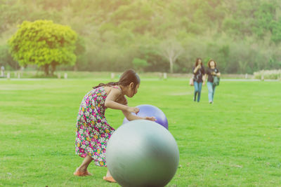 Children playing with ball on field