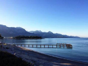 Scenic view of lake against clear blue sky