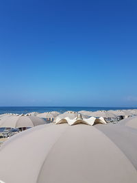 Scenic view of beach against clear blue sky