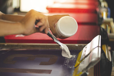 Cropped hand of person working in workshop