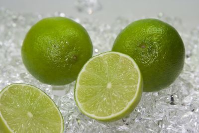 Close-up of green fruit against white background