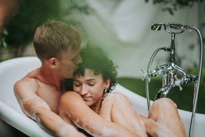 Couple in bathtub outdoors