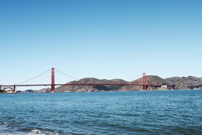 View of suspension bridge over sea