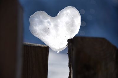 Low angle view of heart shaped against sky