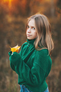 Portrait of a beautiful teenage girl with blond hair and blue eyes with a smile on her face 