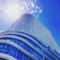 Low angle view of modern building against blue sky