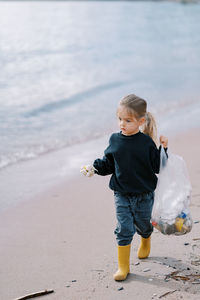 Side view of boy playing at beach