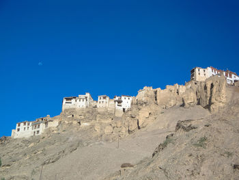 Low angle view of castle against clear blue sky