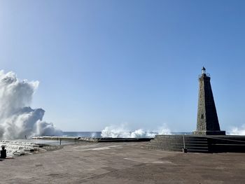 Lighthouse against clear blue sky