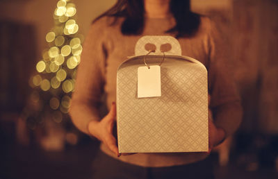 Midsection of woman holding gift box