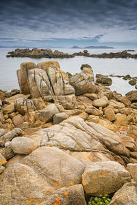 Rocks on shore against sky