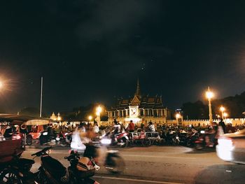 Cars parked on road at night