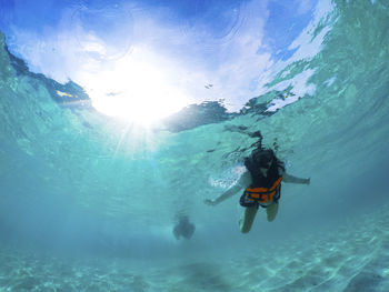 Low angle view of girl swimming undersea