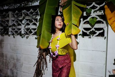 Woman standing against wall