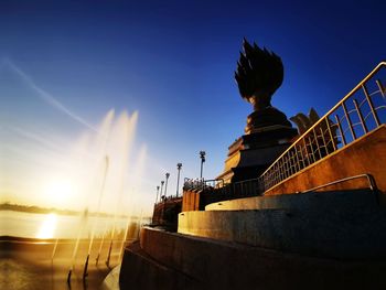 Low angle view of staircase against sky during sunset