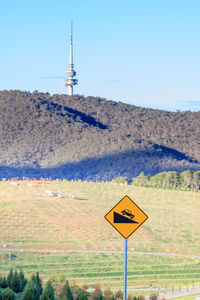 Information sign on landscape against clear sky