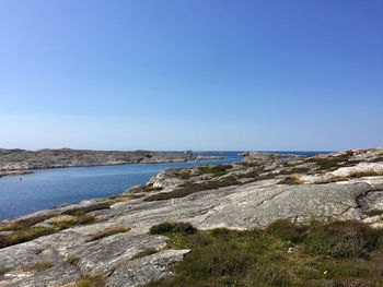 Scenic view of sea against clear blue sky