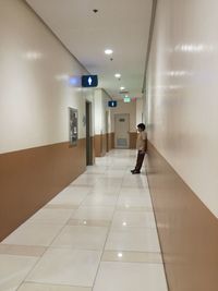 Man walking in corridor of building