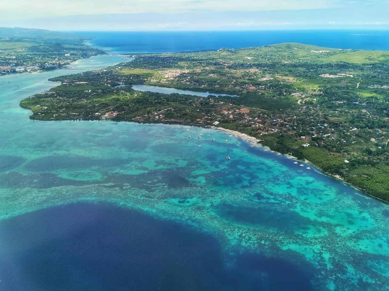 AERIAL VIEW OF SWIMMING POOL AGAINST SEA