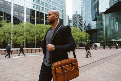 Portrait of young man standing in city