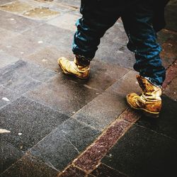 Low section of man standing on street