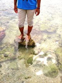 Low section of child standing on beach