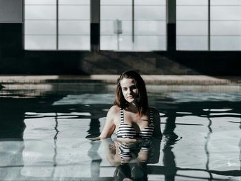 Portrait of young woman in swimming pool
