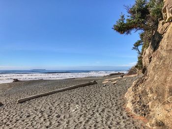 Scenic view of beach against blue sky