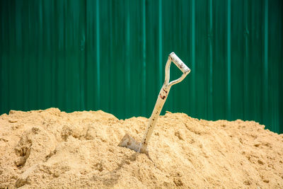 Close-up of shovel in sand
