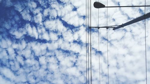 Low angle view of cables against blue sky