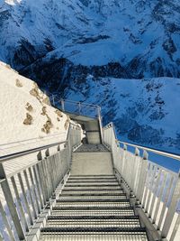 Staircase leading towards snowcapped mountain