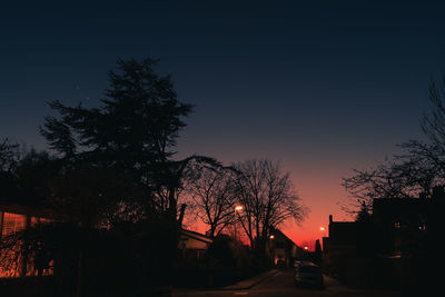 Silhouette trees against sky during sunset