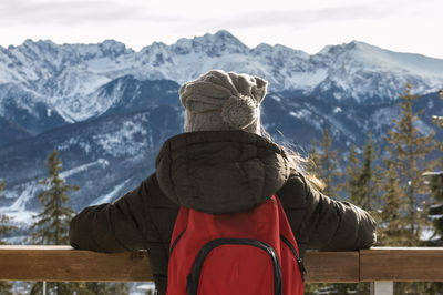 Rear view of woman with mountain in background