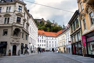 Street amidst buildings in town against sky