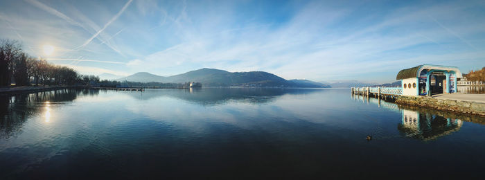 Panoramic view of lake by buildings against sky