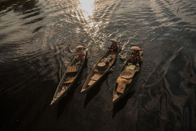 High angle view of people sitting in rowboats