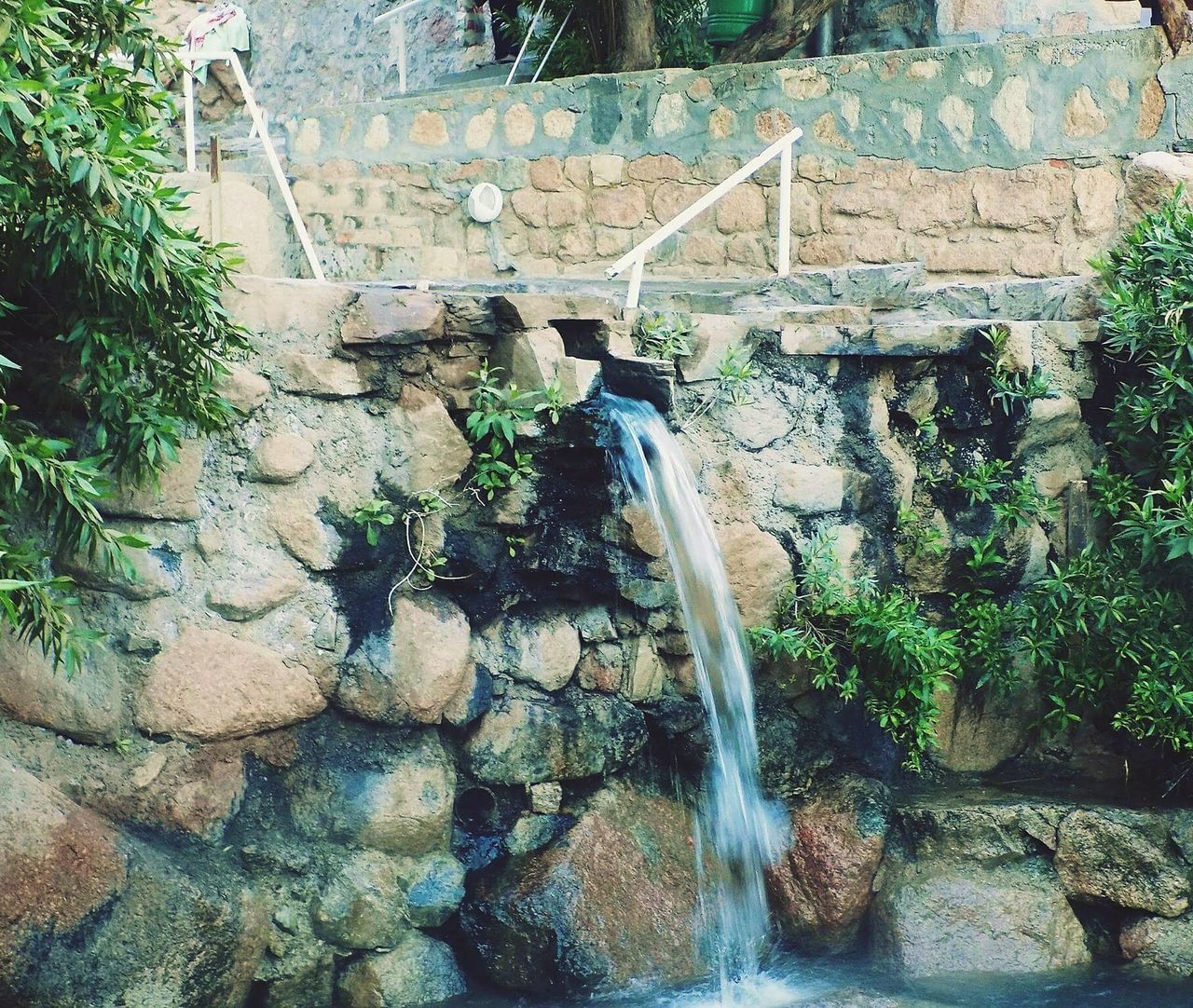 WATER FLOWING THROUGH ROCKS IN THE WATERFALL