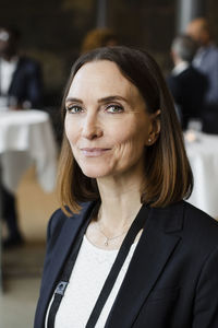 Portrait of confident businesswoman at seminar in convention center