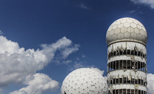 Low angle view of modern sculpture against cloudy sky