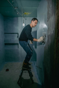 Side view of man working at construction site