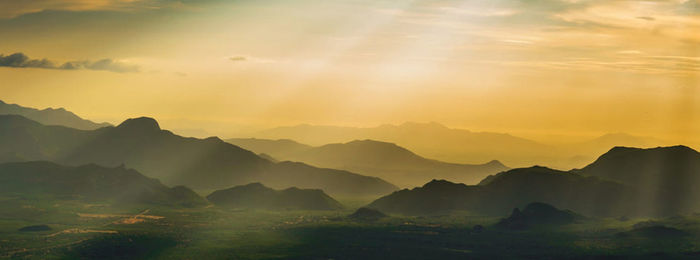 Scenic view of silhouette mountains against sky during sunset