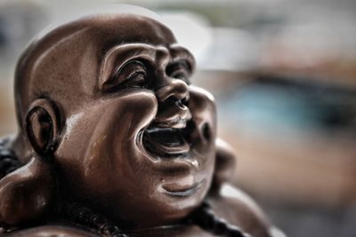 Close-up of laughing buddha statue