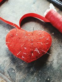 Close-up of heart shaped pin cushion on table