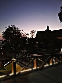 Silhouette bridge against clear sky at sunset