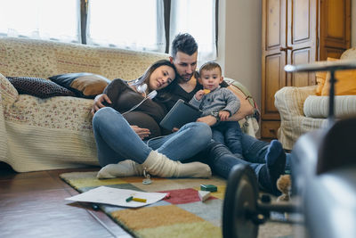 High angle view of children sitting on sofa