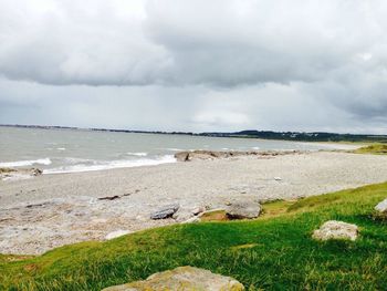 Scenic view of landscape against cloudy sky